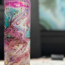 Colorful tumbler with pink, blue, and gold abstract swirls