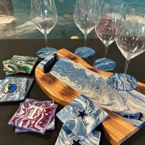 Wine glasses and marble coasters on a wooden board.